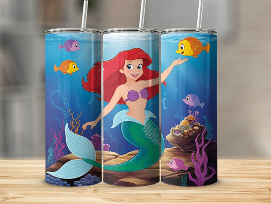 Ariel the mermaid smiles, surrounded by colorful fish and coral.