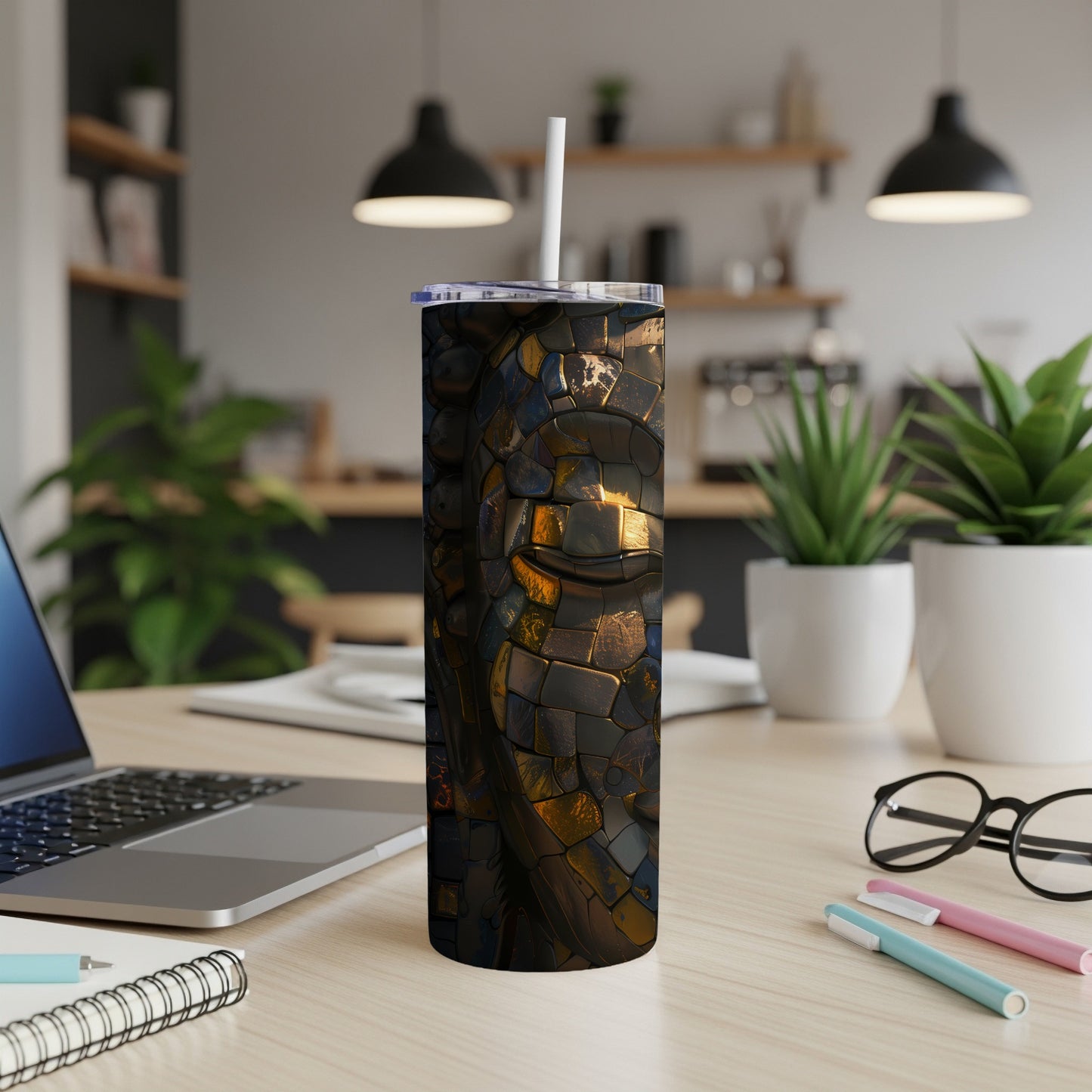 Dragon scale pattern tumbler with straw, on a desk.