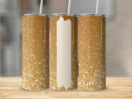 Three glittery gold tumblers with white straws on a wooden surface.