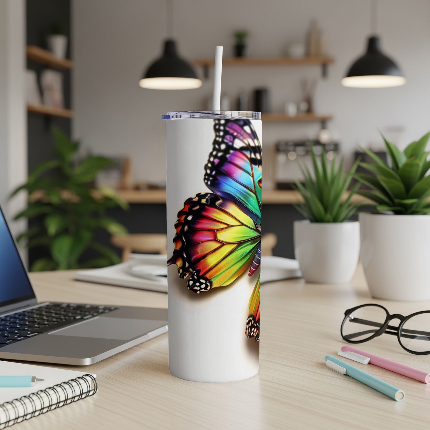 White tumbler with vibrant rainbow butterfly graphic.