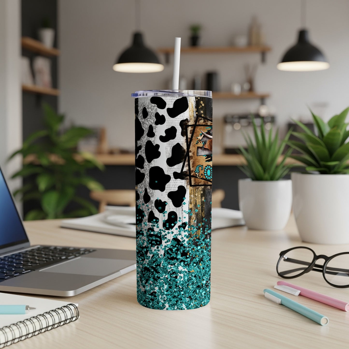 Cow print tumbler with turquoise glitter and rustic wood design.