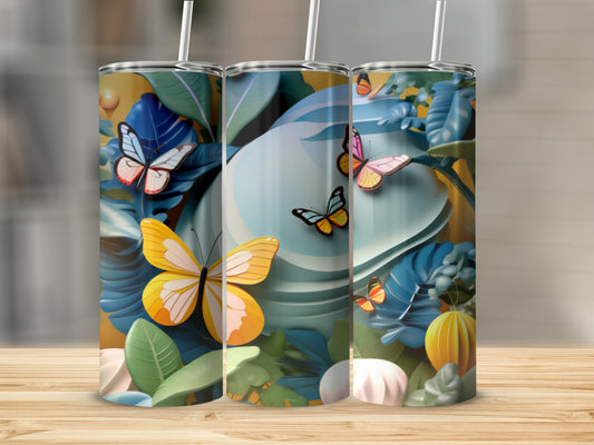 Three tumblers with a floral and butterfly design, displayed on a wooden surface.