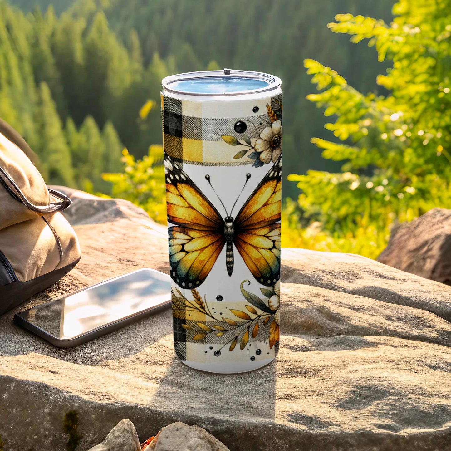 Butterfly and floral design on a white tumbler with plaid accents.