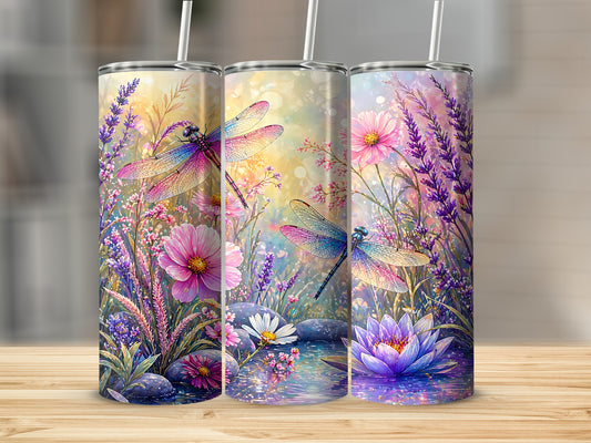 Three tumblers with dragonflies and flowers against a colorful bokeh background.