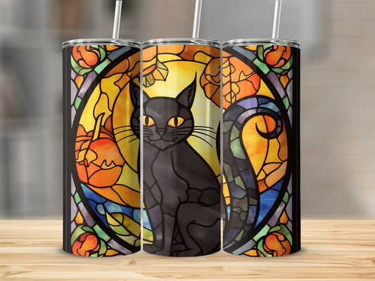 Black cat with yellow eyes in stained glass design with pumpkins and autumn leaves.