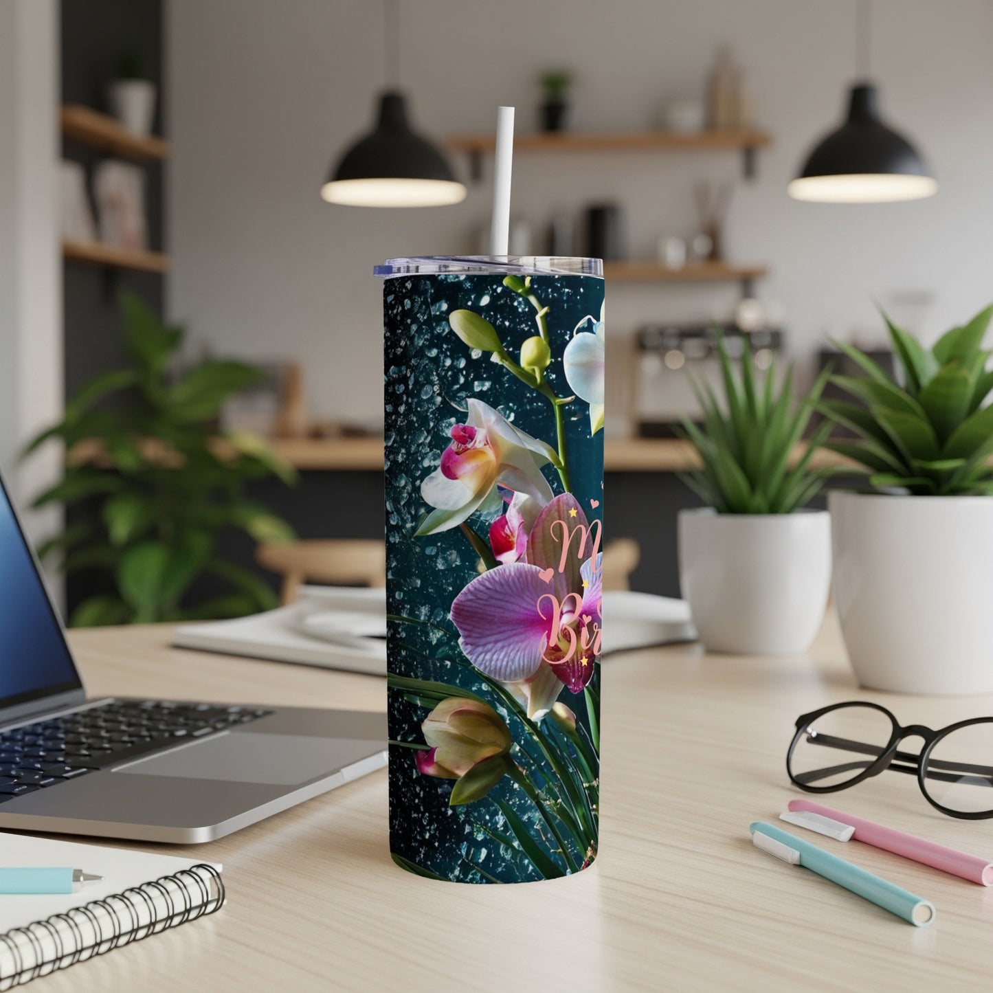 Dark background tumbler with orchids and water droplets.