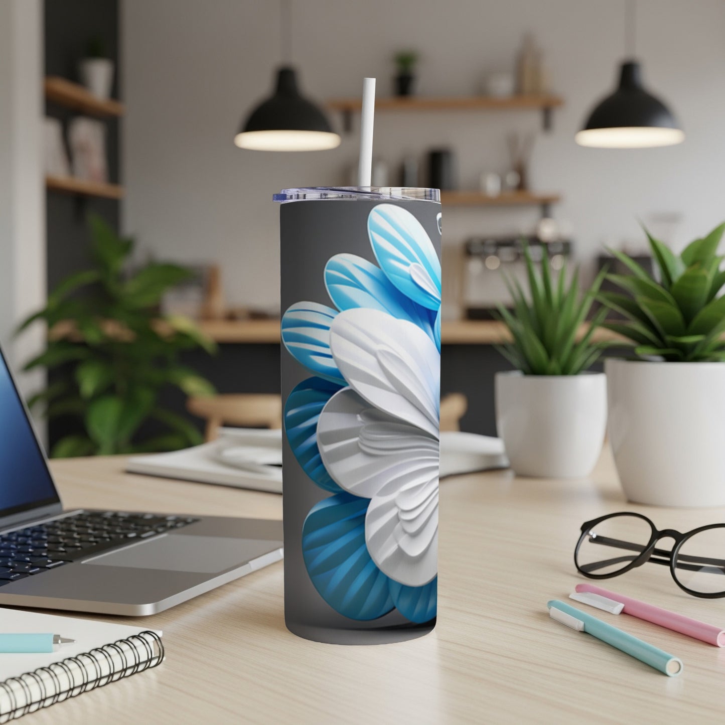 Gray tumbler with blue and white floral design and straw.