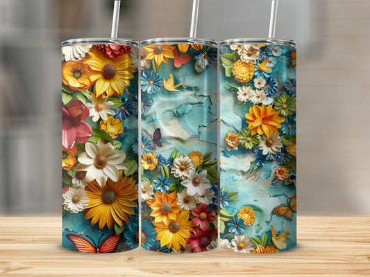 Three tumblers with colorful floral designs and butterflies on a textured background.