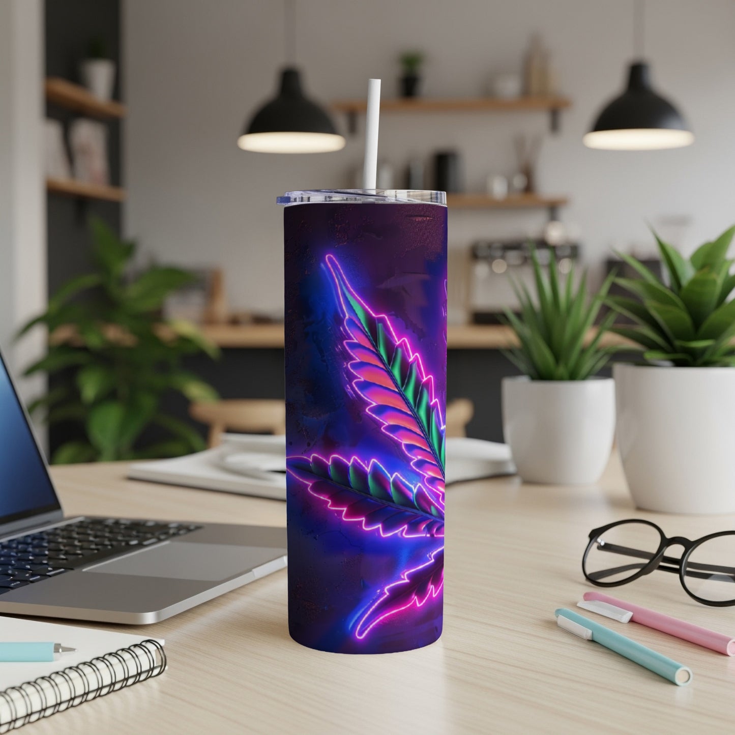 Neon cannabis leaf on a purple tumbler with a straw, on a desk.