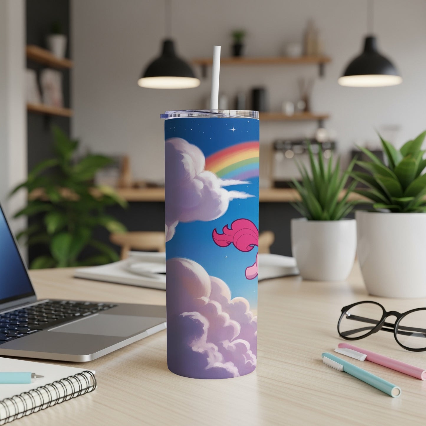 Unicorn and rainbow design on a white tumbler with a straw.
