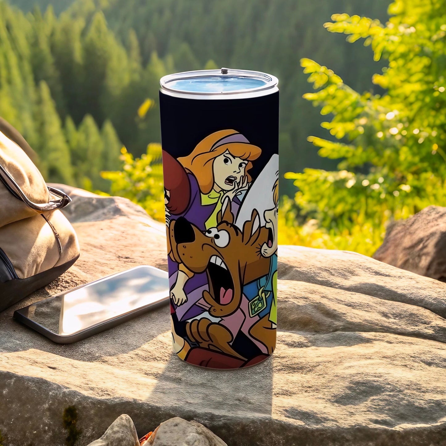 Scooby-Doo characters on a stainless steel tumbler with outdoor background.