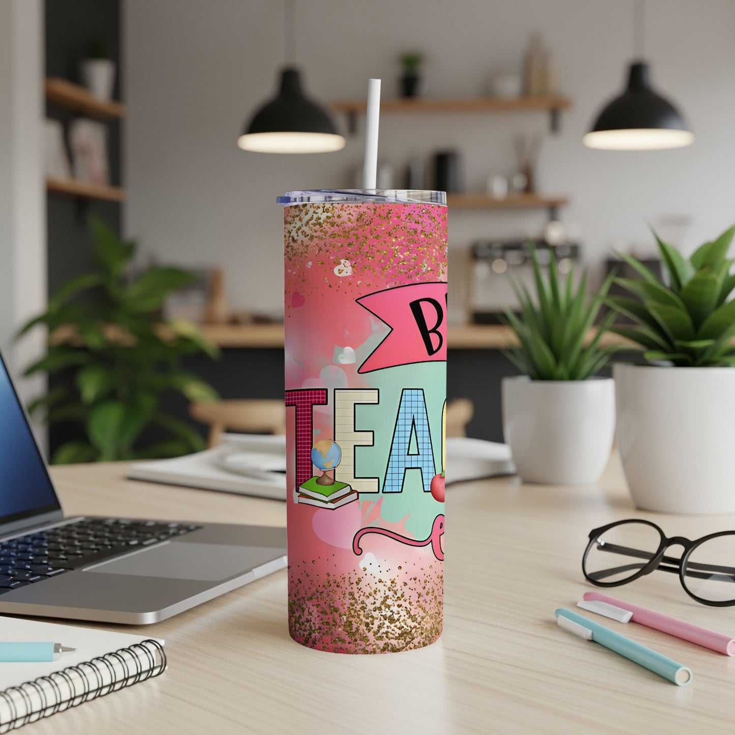 Pink tumbler with "Best Teacher" text, glitter, and school icons.