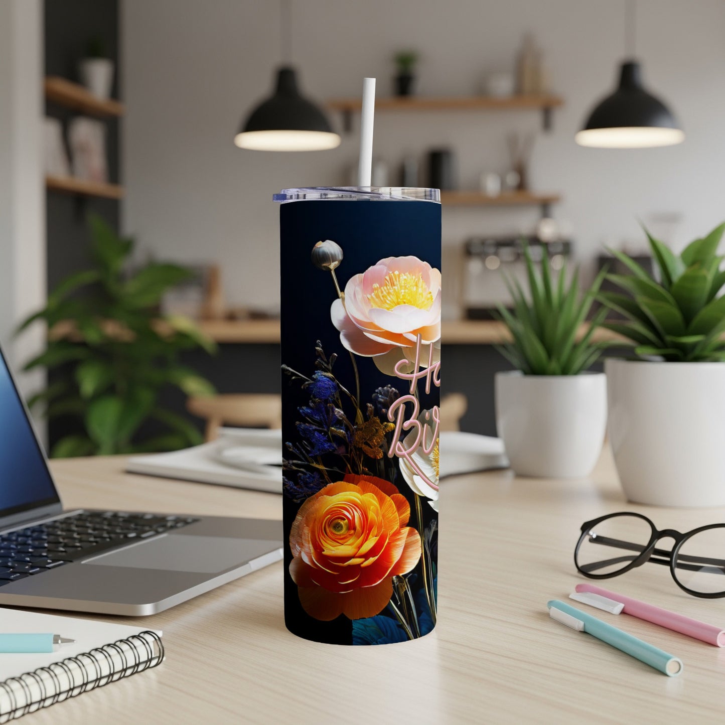 Floral tumbler with "Happy Birthday" text, featuring a laptop and office supplies.