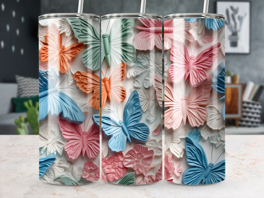 Three tumblers with a textured butterfly and floral design in pastel colors.