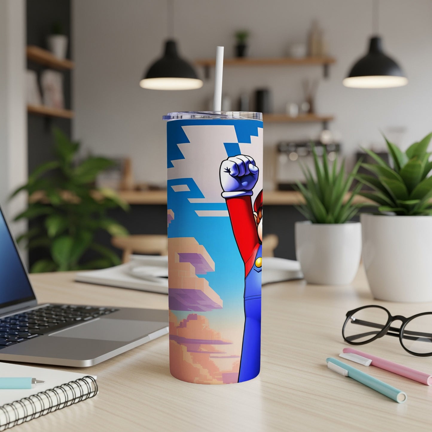 Mario character on a colorful tumbler with a laptop and desk accessories.