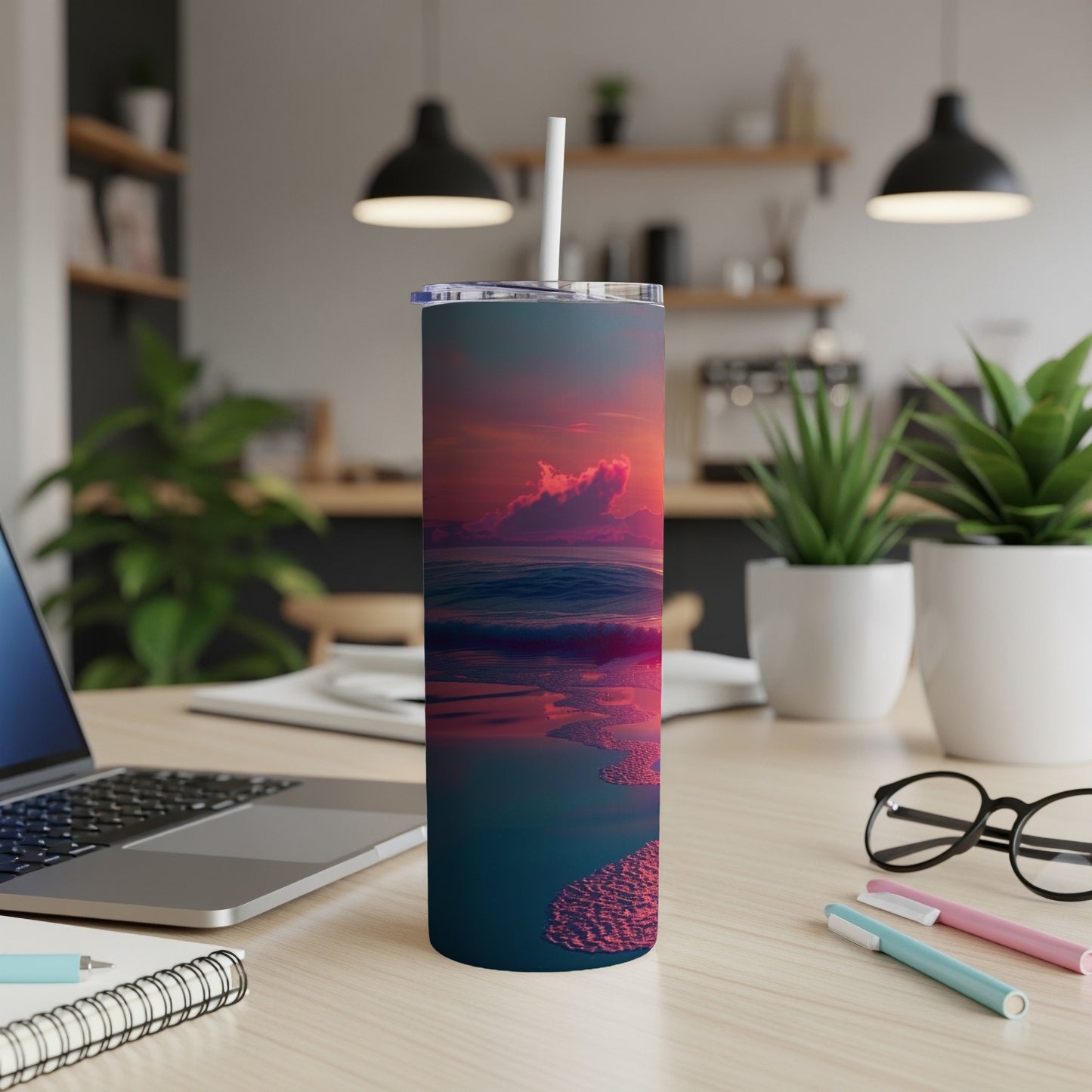 Sunset ocean waves and sandy shore design on a tumbler with straw.