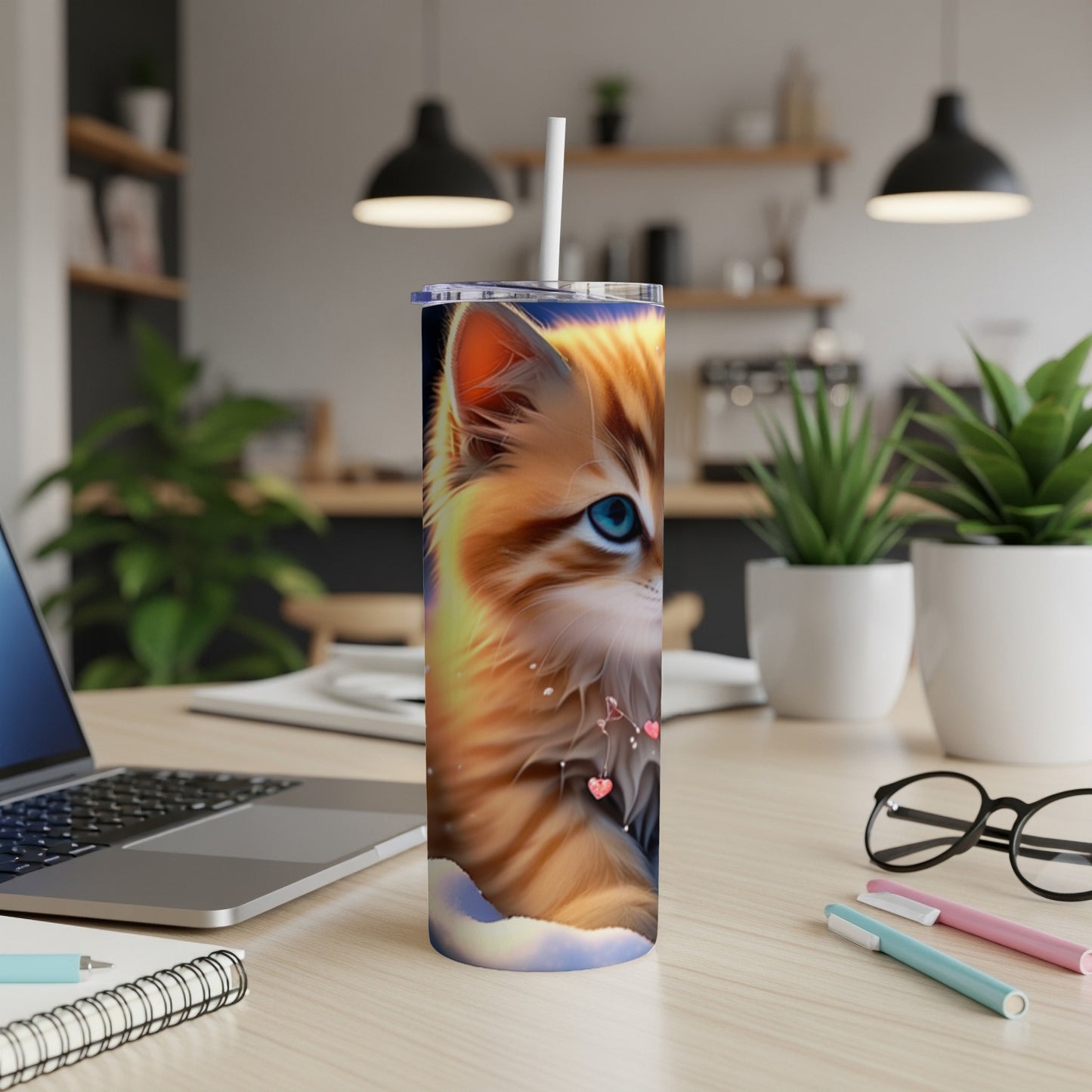 Orange tabby cat with blue eyes on a tumbler, with a straw.