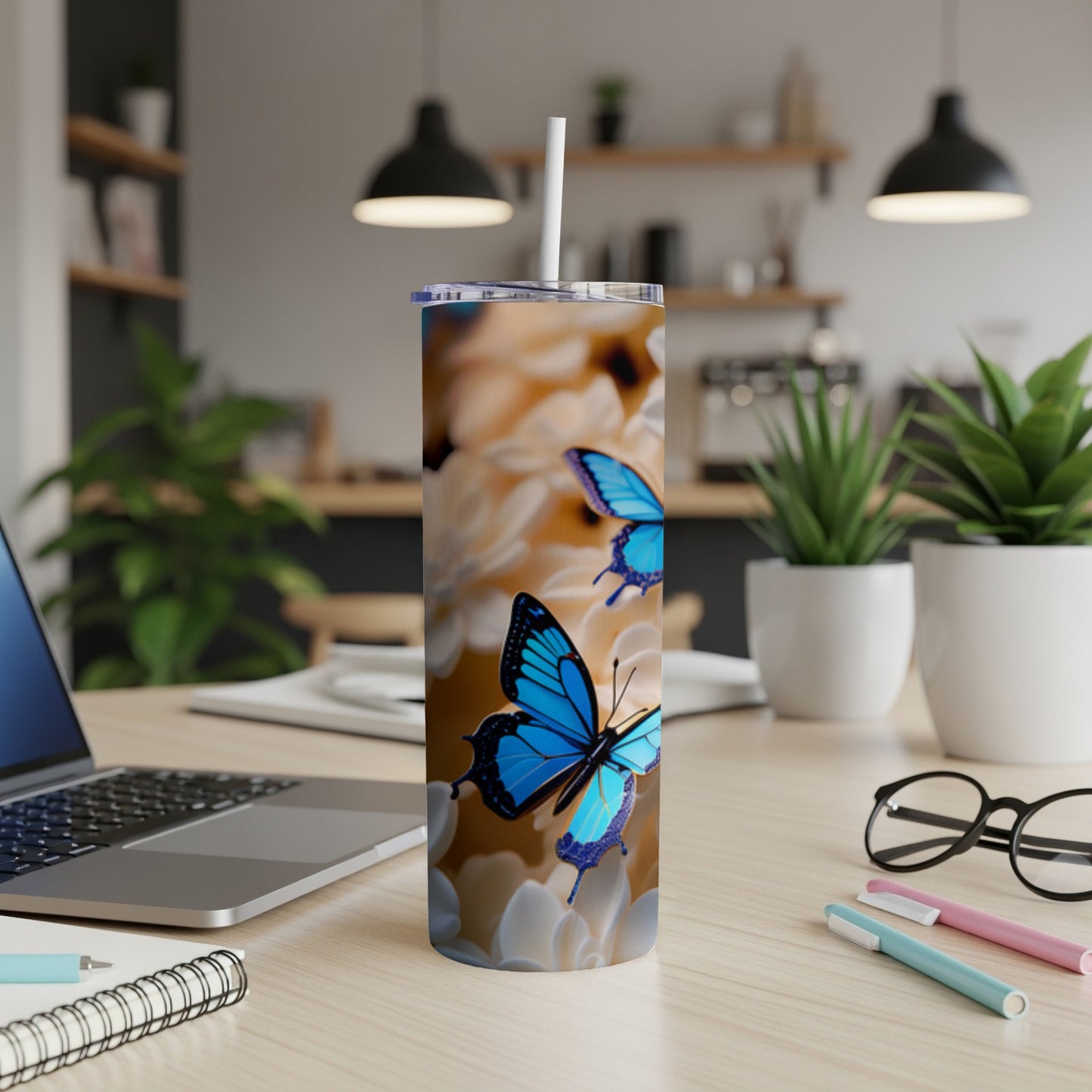 Blue butterflies on a floral pattern skinny tumbler with straw.