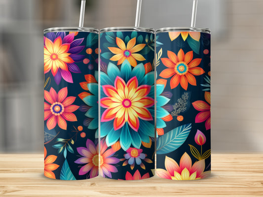 Three tumblers with vibrant floral designs on a wooden surface.