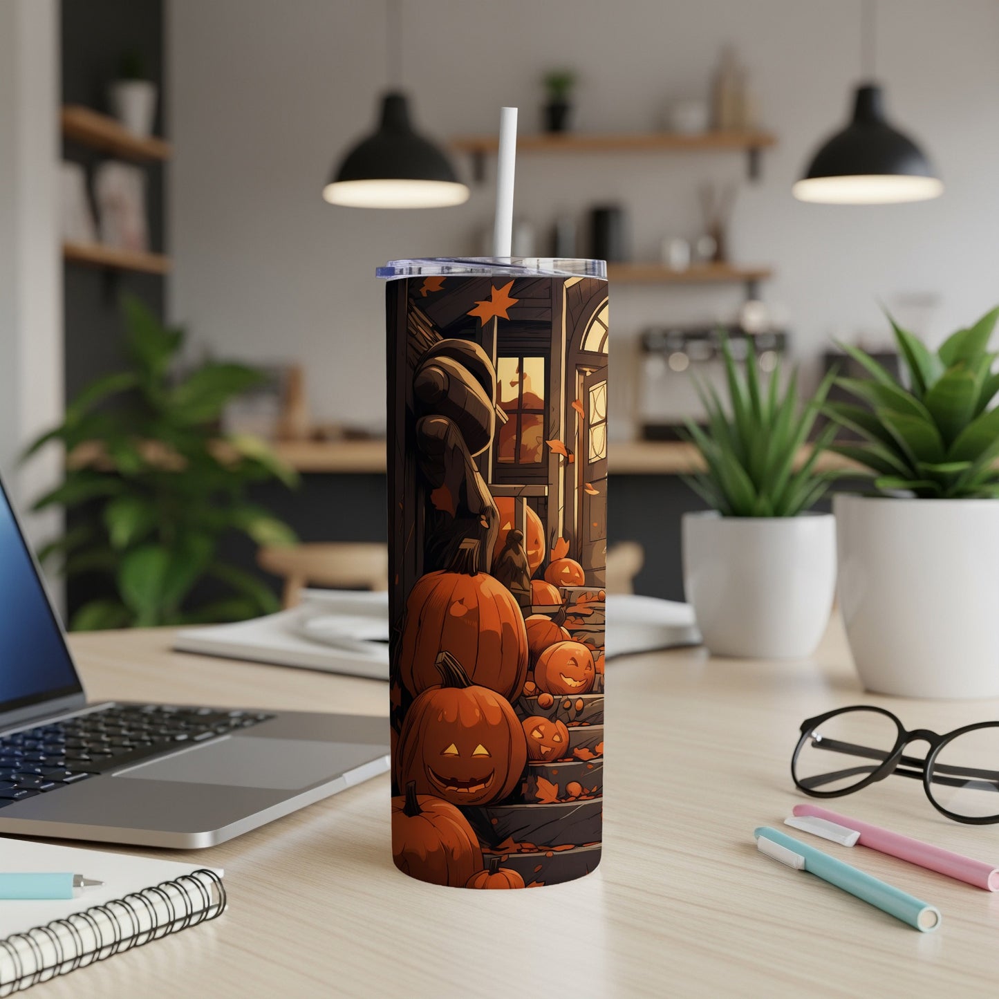Tumbler with cartoon pumpkins and falling leaves on a porch.