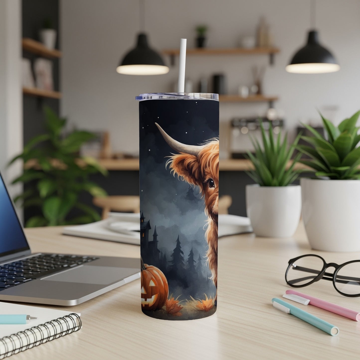 Highland cow and jack-o'-lantern Halloween design on a tumbler.