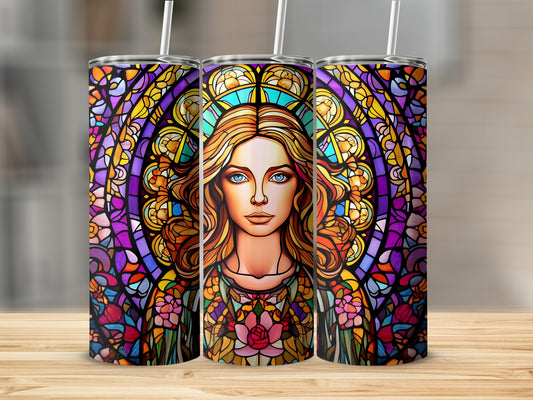 Stained glass tumbler with woman's portrait and floral accents.