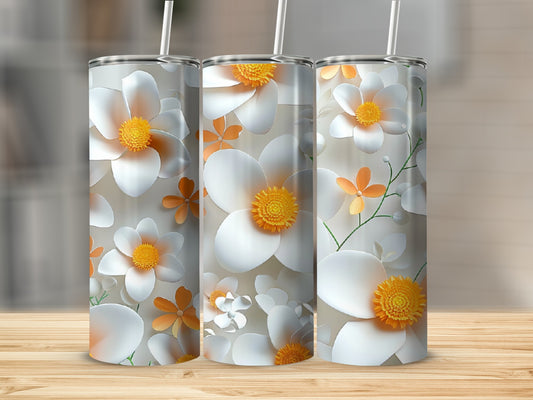 Three tumblers with white and orange floral patterns on a wooden surface.