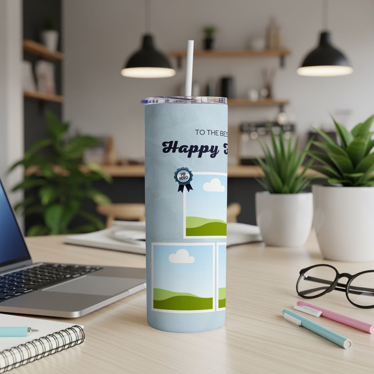 Light blue tumbler with "Happy Birthday" and "My Hero" graphics, sitting on a desk.