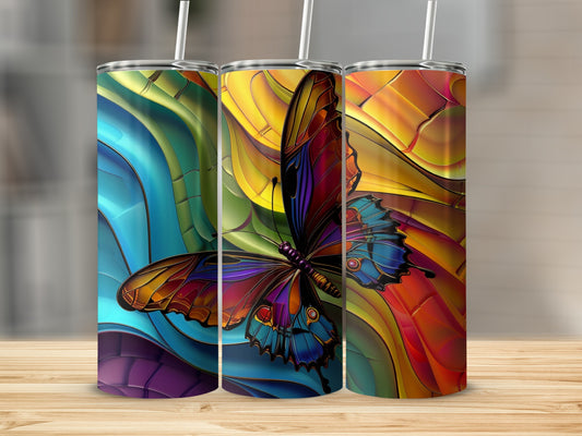 Three tumblers with vibrant stained-glass butterfly designs on a wooden surface.