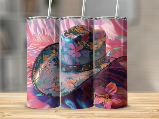 Three cowboy hats with floral designs on a wooden surface.