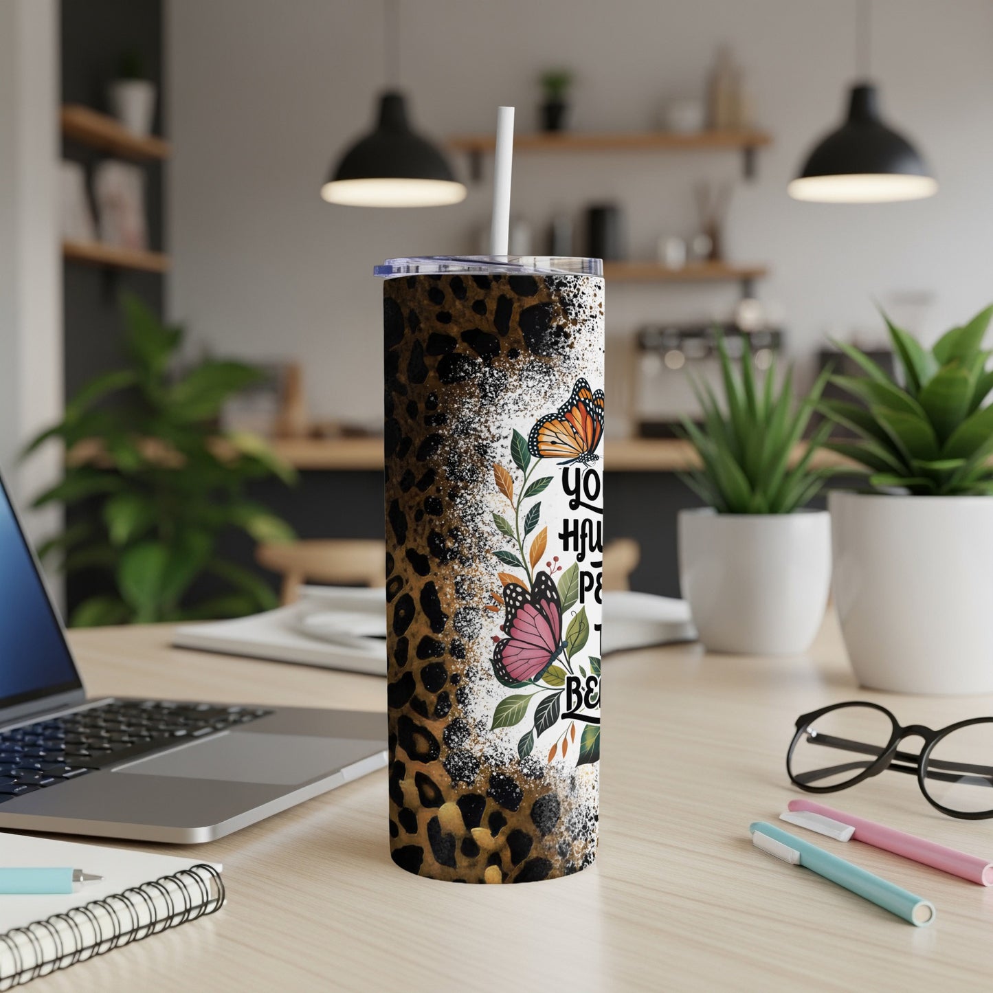 Leopard print tumbler with colorful butterflies and inspirational text.
