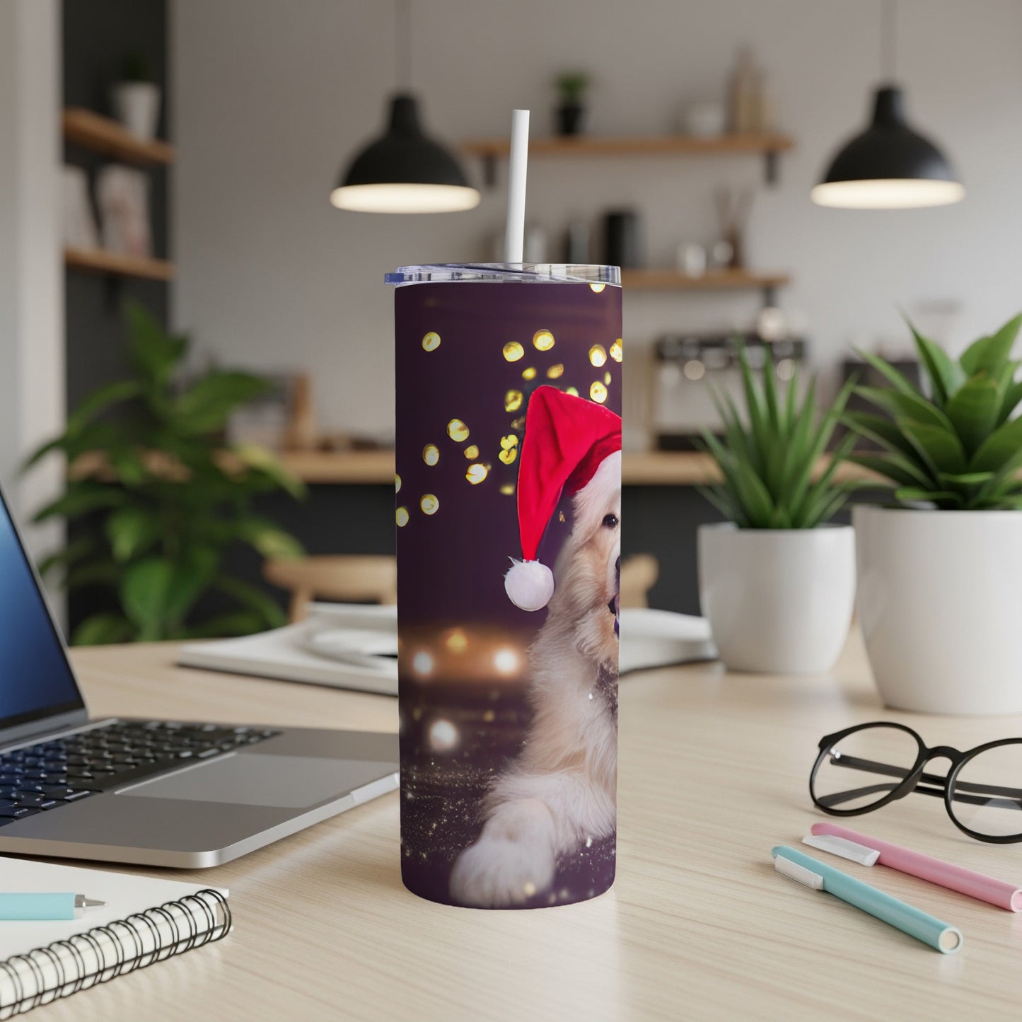 Golden retriever puppy in Santa hat on a purple tumbler with bokeh lights.