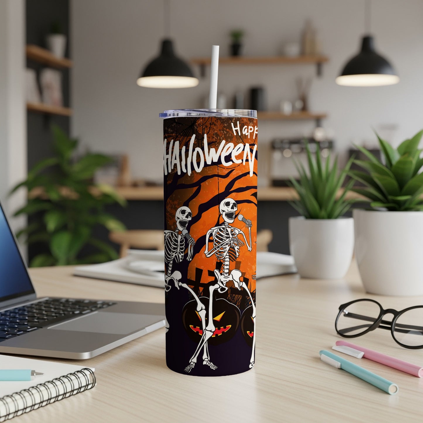 Tumbler with skeletons singing and pumpkins, says "Happy Halloween"