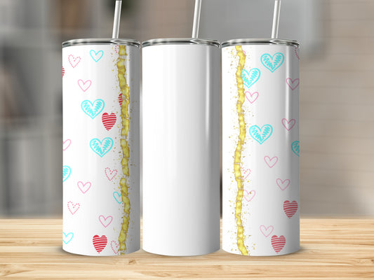 Three white tumblers with pink and blue hearts and gold accents on a wooden surface.