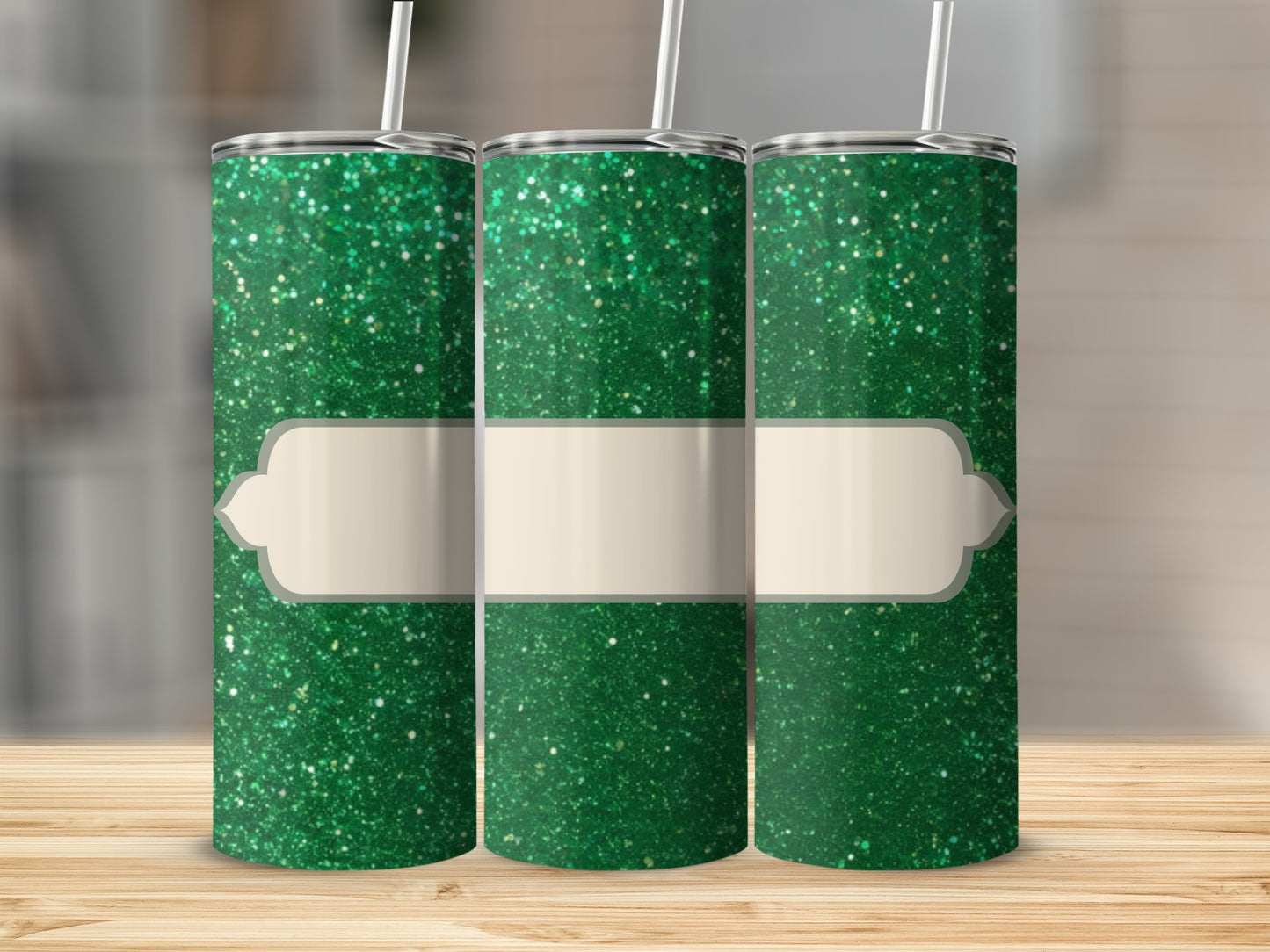 Three green glitter tumblers with blank cream labels.