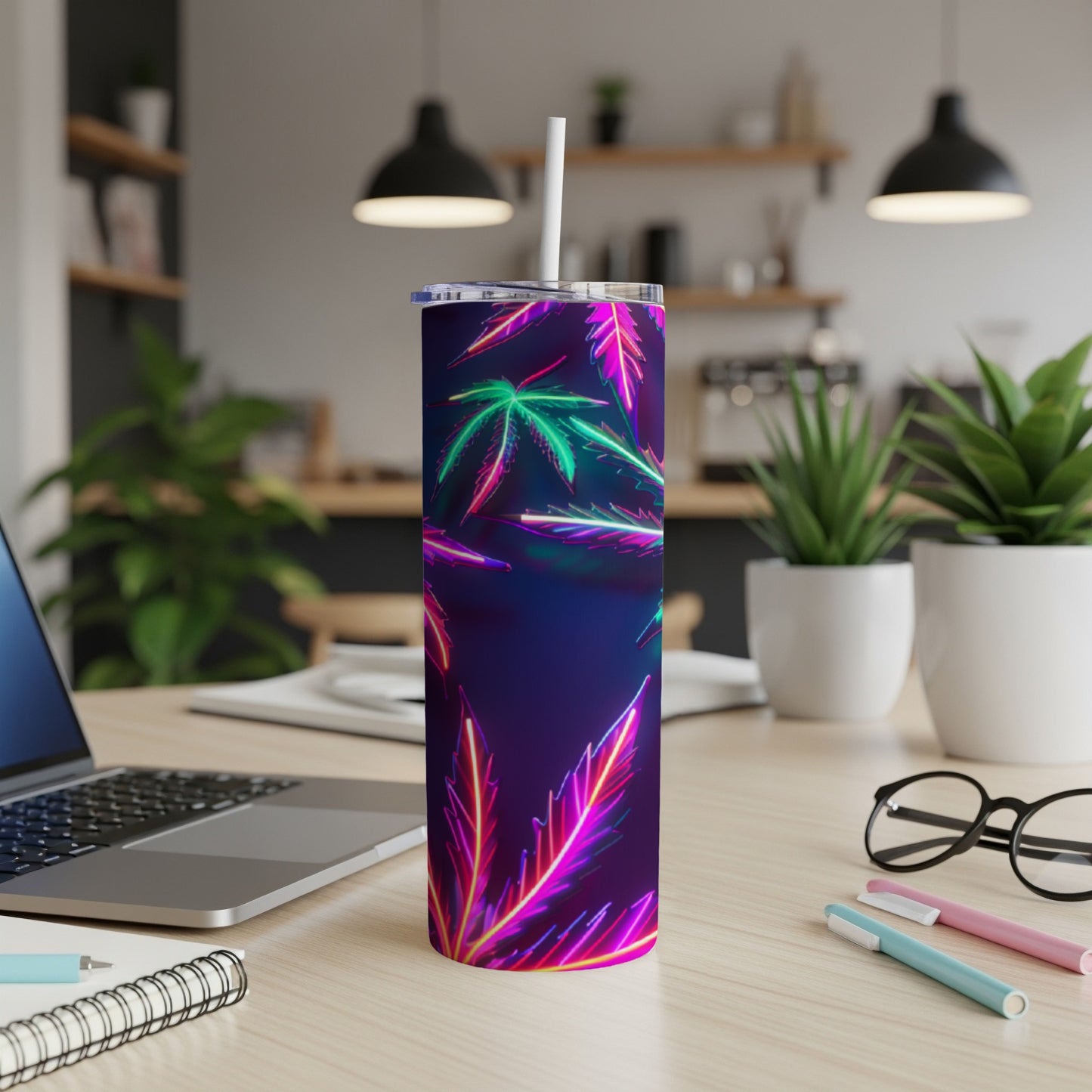 Purple tumbler with neon cannabis leaf design and white straw.