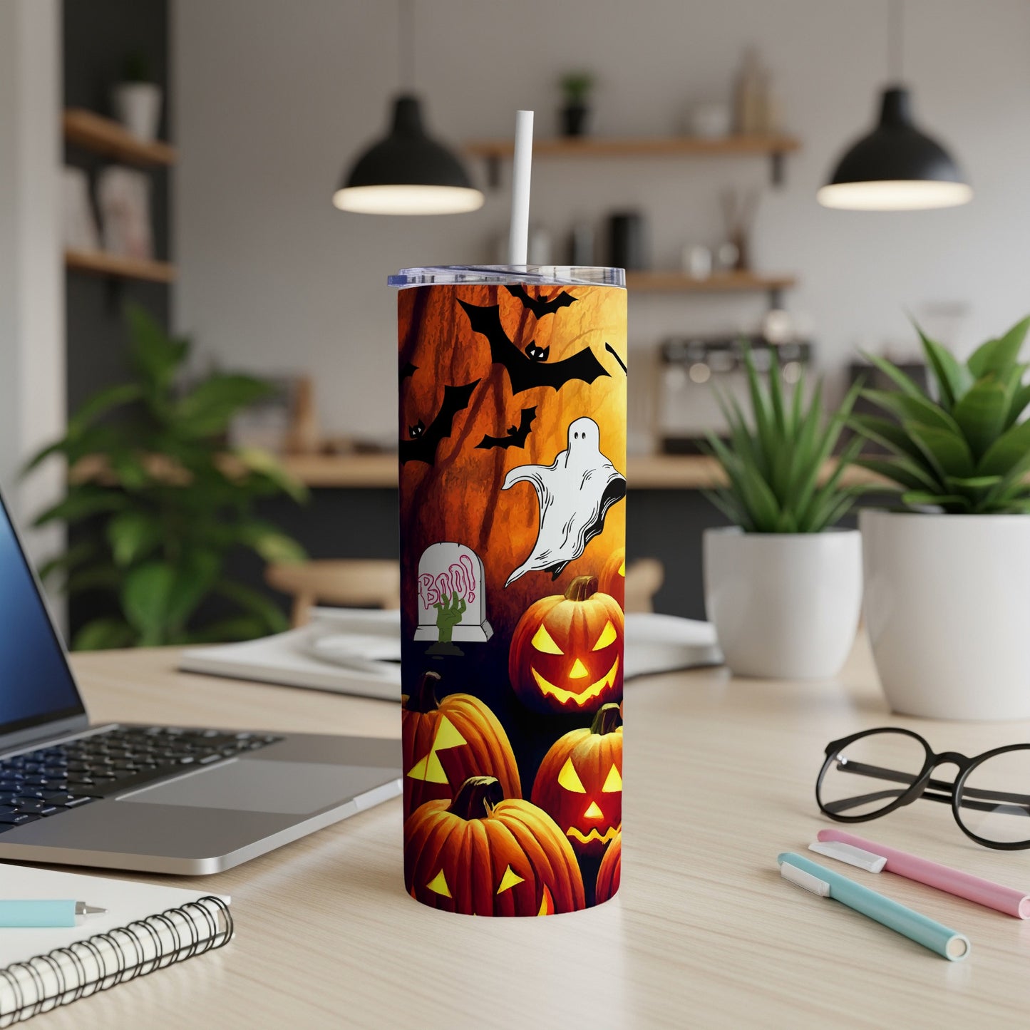 Halloween tumbler with pumpkins, bats, ghost, and tombstone design.