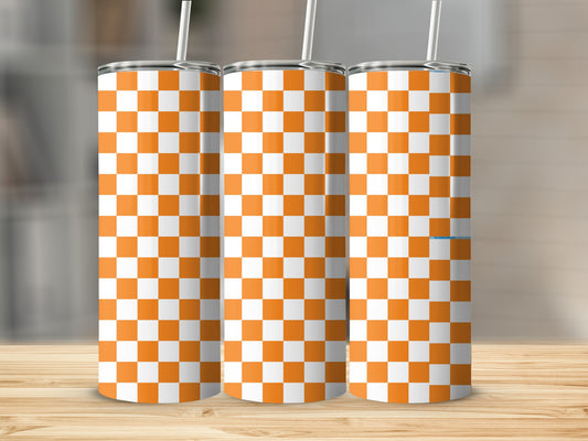 Three tumblers with orange and white checkered pattern on a wooden surface.
