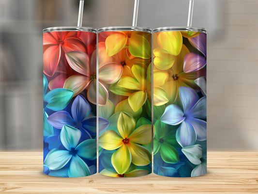 Three tumblers with vibrant rainbow floral designs on a wooden surface.