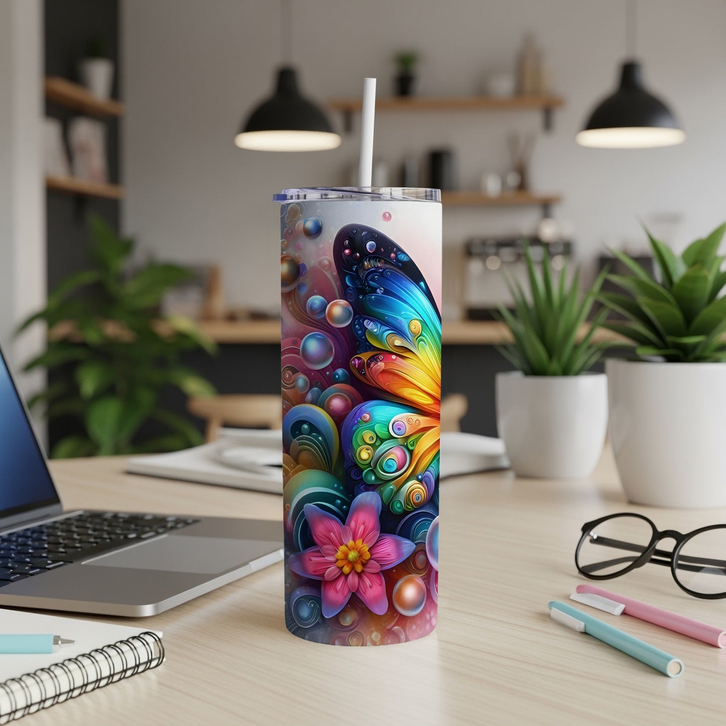 Colorful butterfly and floral pattern on a white tumbler with straw.