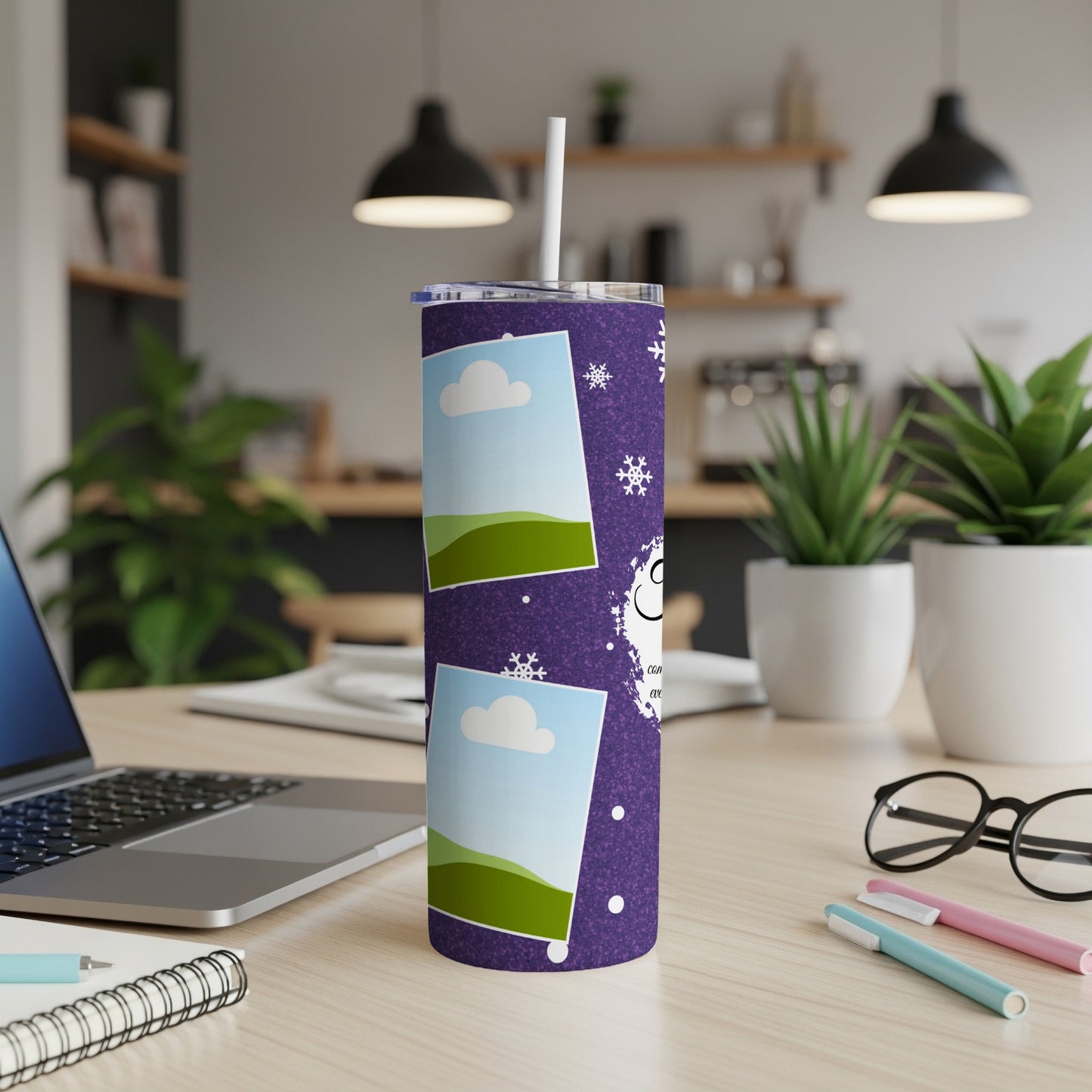 Purple tumbler with photo frames, snowflakes, and the word "CON" on a desk.