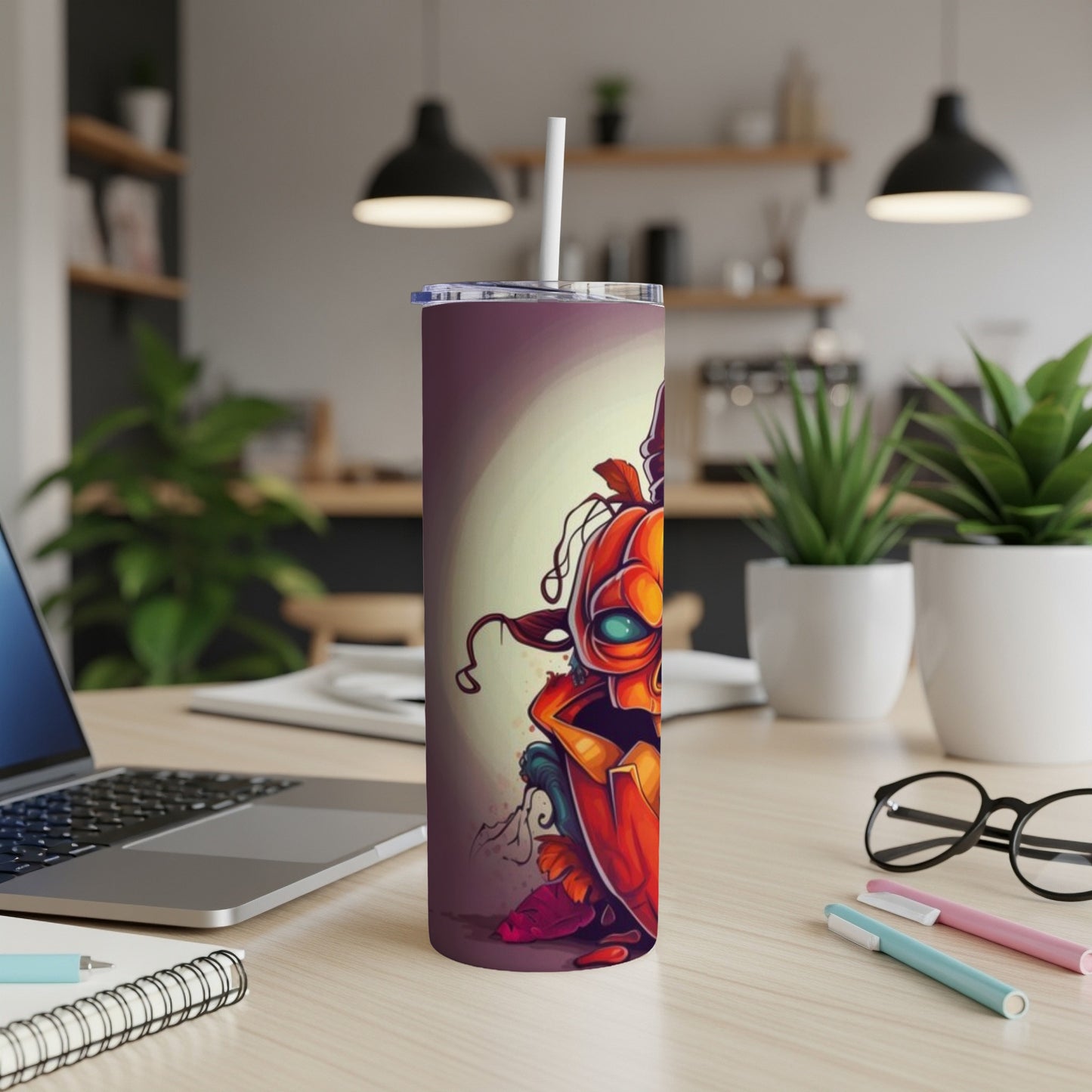 Tumbler with a stylized, fierce jack-o'-lantern illustration and a white straw.