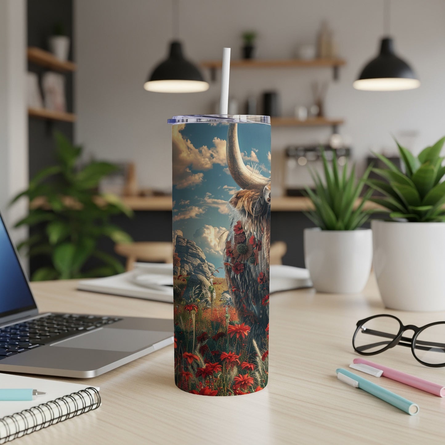 Highland cow with floral accents on a skinny tumbler with straw.