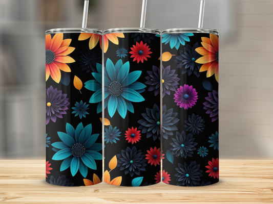 Three tumblers with colorful floral designs on a wooden surface.