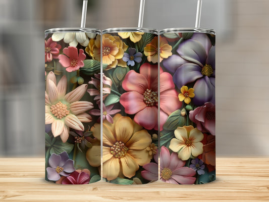 Three tumblers with detailed floral designs in vibrant colors.