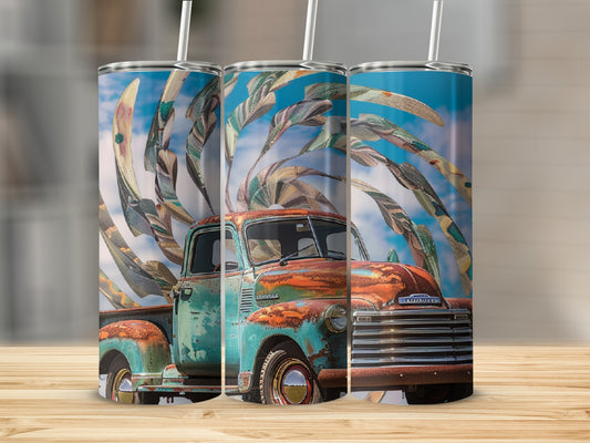 Rusty blue vintage truck with abstract colorful leaves design on tumbler.