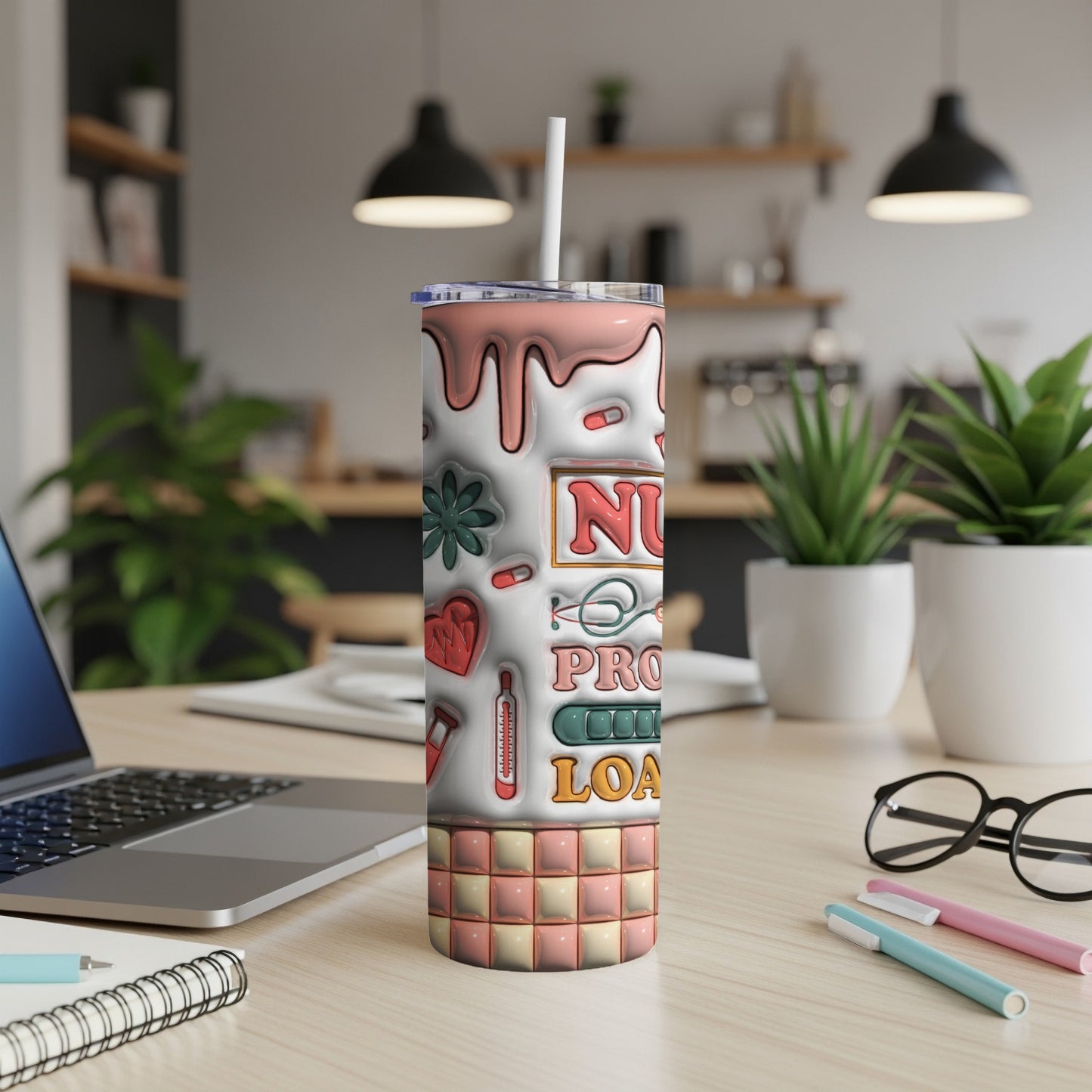 Tall tumbler with nurse-themed graphics and checkered base on a desk.