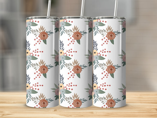 Three tumblers with a floral pattern on a wooden surface.