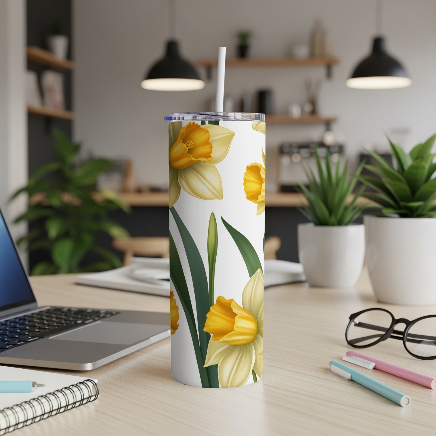 White tumbler with yellow daffodils and green leaves pattern.
