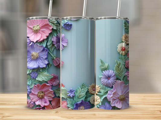 Three tumblers with textured floral designs in pink, purple, and green on a light blue background.